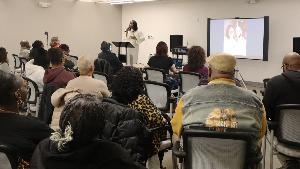 Cheryl Moten stands at the front of the room, presenting at the second edition of Talking Points.