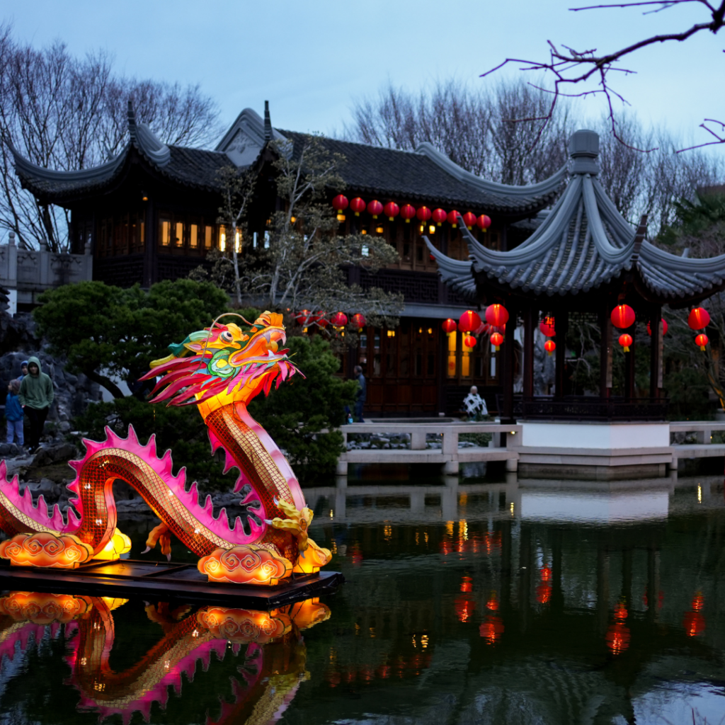 A dragon sits on a lake at Lan Su Chinese Garden, lit up in celebration of the Lunar New Year.